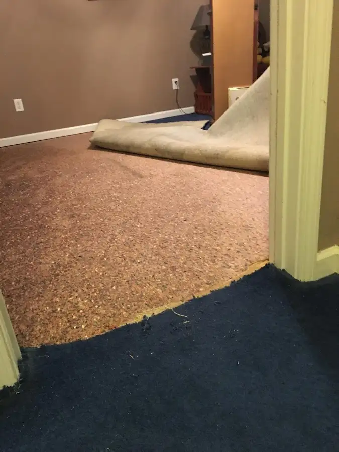 Carpet pad removal revealing water damage during Drying & Dehumidification in Lawton