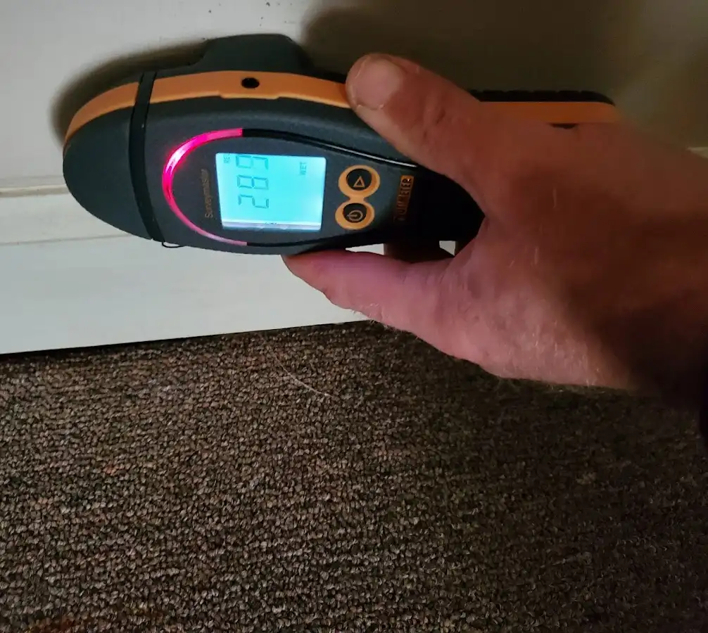 Moisture detection at baseboard during Storm Damage Restoration in Lawton